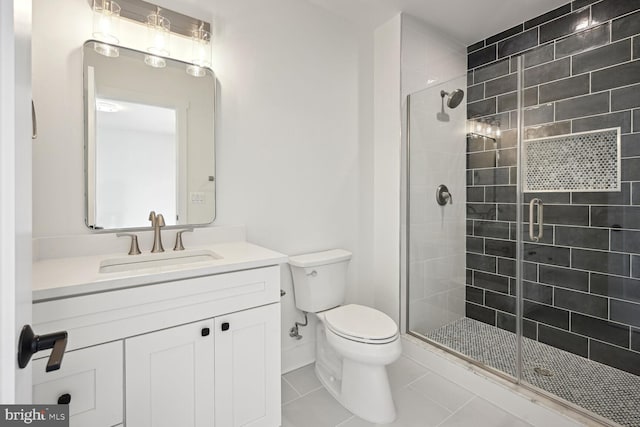 full bath featuring toilet, tile patterned flooring, a shower stall, and vanity