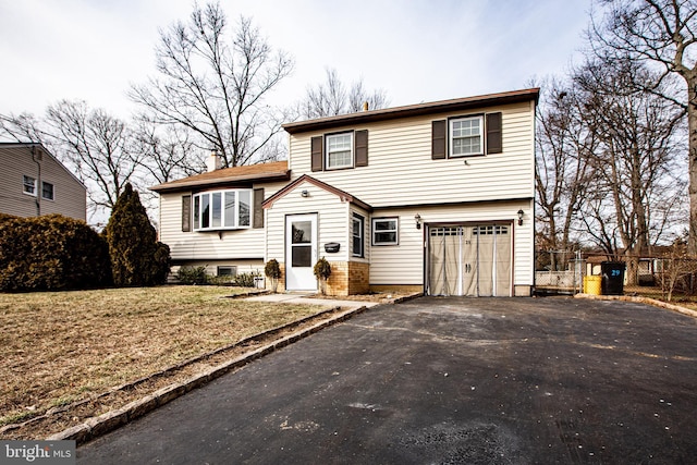 view of front of house with a garage and a front yard