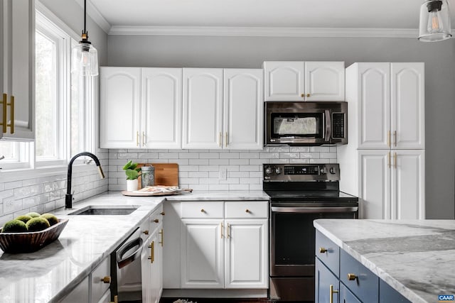 kitchen featuring sink, white cabinetry, stainless steel appliances, light stone counters, and decorative light fixtures