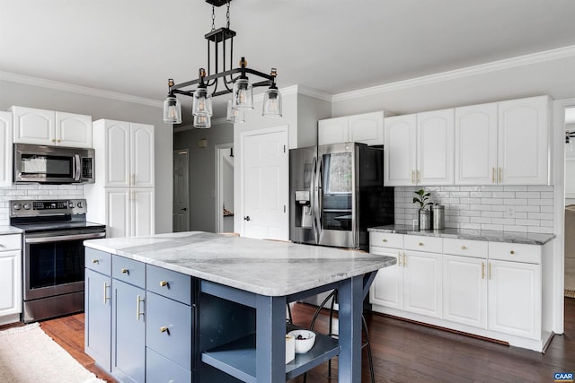 kitchen with white cabinetry, stainless steel appliances, and a center island