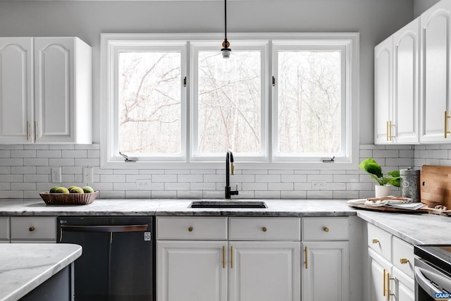 kitchen featuring hanging light fixtures, dishwasher, sink, and white cabinets