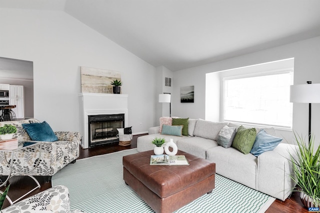 living room featuring hardwood / wood-style flooring and vaulted ceiling