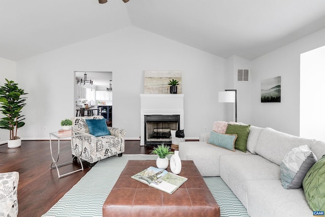 living room with lofted ceiling and dark hardwood / wood-style flooring