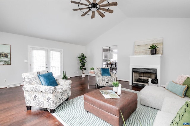 living room with dark hardwood / wood-style flooring, vaulted ceiling, french doors, and ceiling fan