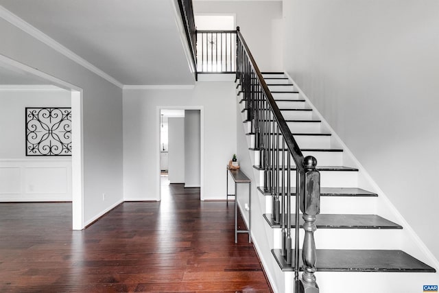 stairway featuring hardwood / wood-style flooring and crown molding