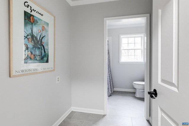 bathroom with crown molding, tile patterned floors, and toilet