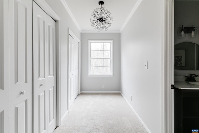 hallway with light carpet, ornamental molding, and a chandelier