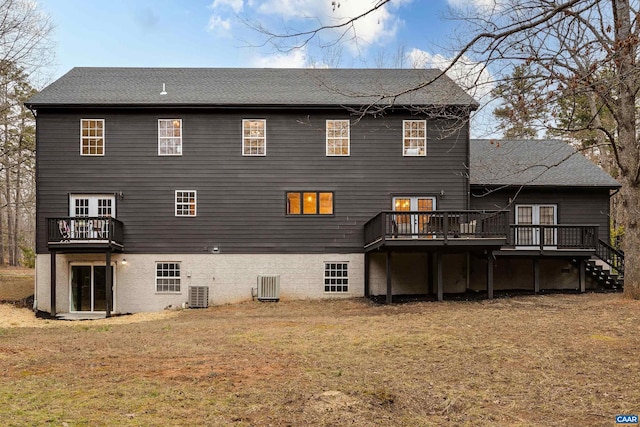 back of house featuring a wooden deck, a yard, and central AC