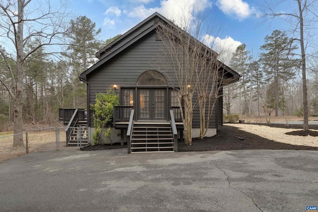 view of front of house featuring a wooden deck and french doors