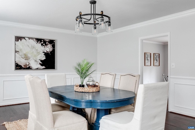 dining room with crown molding and dark wood-type flooring