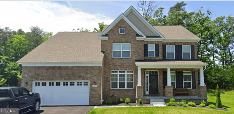 craftsman-style home featuring covered porch and a front lawn