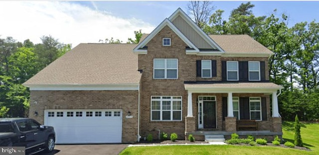 craftsman house with aphalt driveway, brick siding, covered porch, and a garage