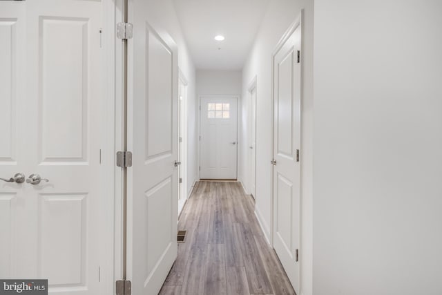 hall featuring visible vents, recessed lighting, and light wood-style floors