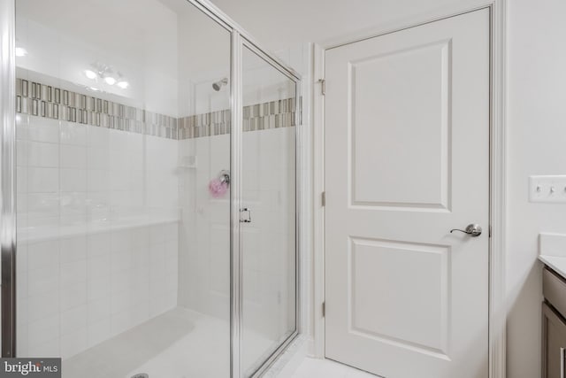 full bath with a stall shower and vanity