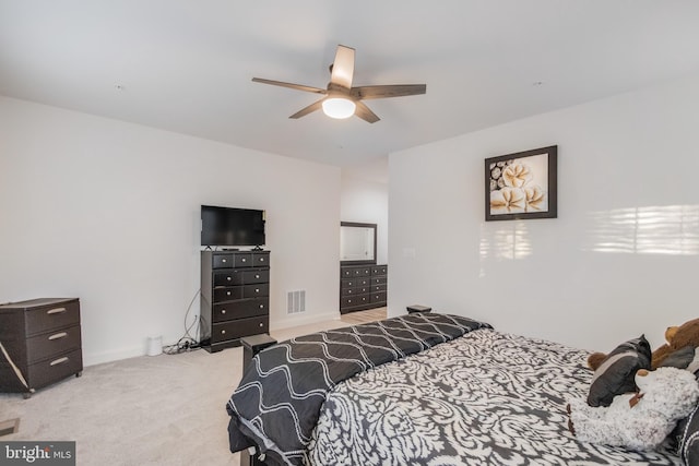 bedroom featuring ceiling fan, baseboards, visible vents, and light carpet