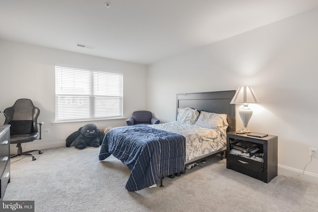 carpeted bedroom featuring visible vents and baseboards