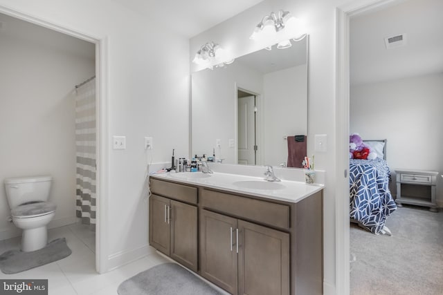 ensuite bathroom with double vanity, visible vents, connected bathroom, and a sink