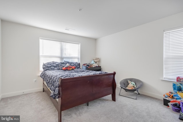 carpeted bedroom with baseboards