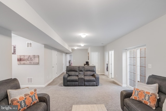 carpeted living area with baseboards and visible vents