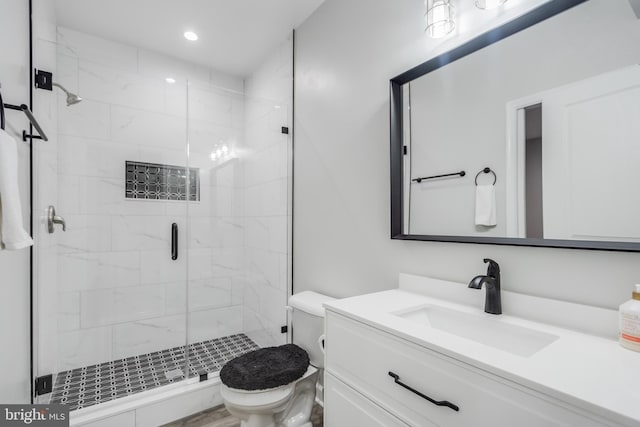 full bath featuring vanity, toilet, recessed lighting, and a stall shower