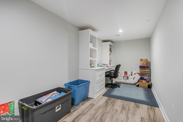 office area featuring light wood-style flooring and baseboards