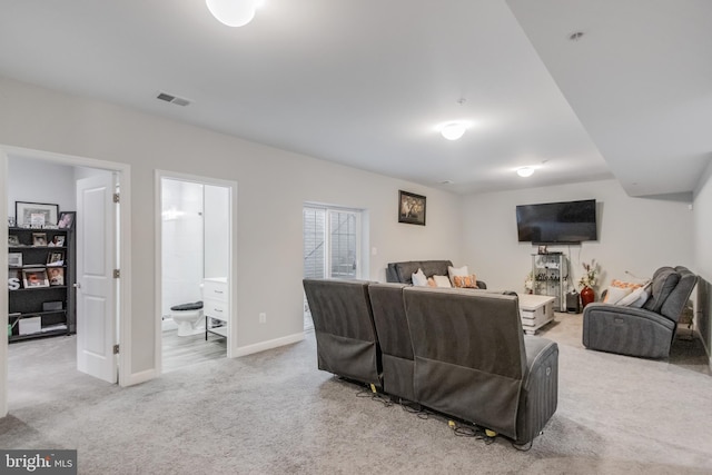 living room featuring visible vents, light carpet, and baseboards