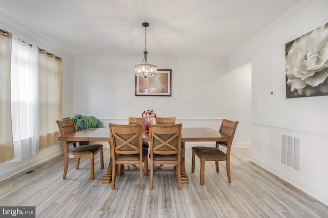 dining room with a wealth of natural light, visible vents, and crown molding