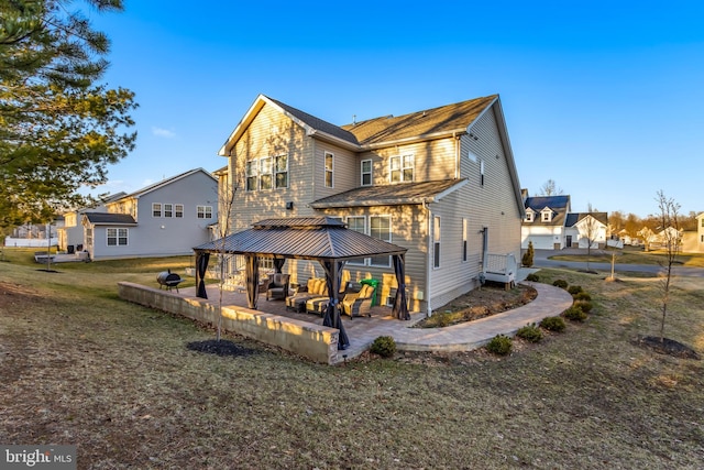 rear view of house with a gazebo, a residential view, a patio, and a lawn