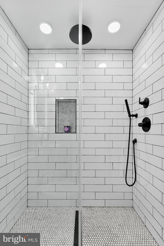 bathroom with tiled shower