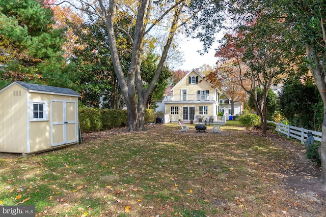 view of yard with an outdoor fire pit and a shed