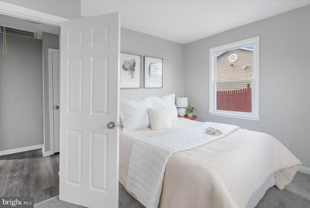 bedroom with dark hardwood / wood-style flooring