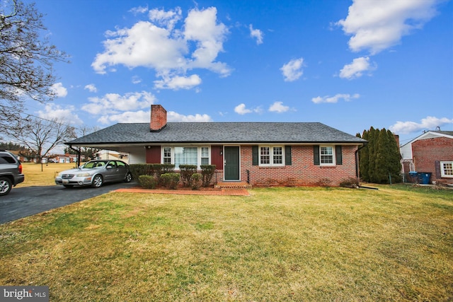 ranch-style house featuring a carport and a front yard