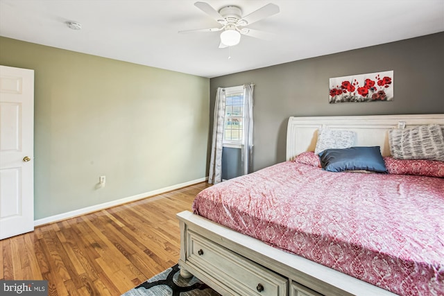 bedroom with hardwood / wood-style floors and ceiling fan