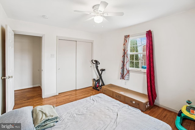 bedroom featuring hardwood / wood-style flooring, a closet, and ceiling fan