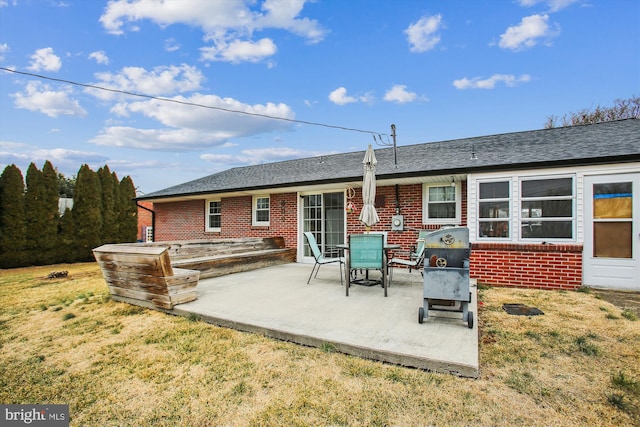 back of property featuring a yard and a patio area