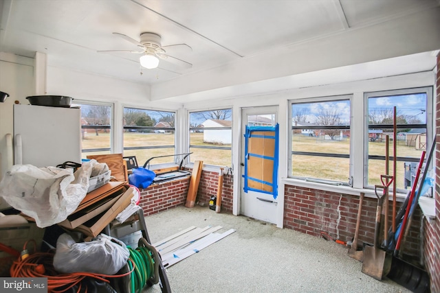 sunroom featuring ceiling fan