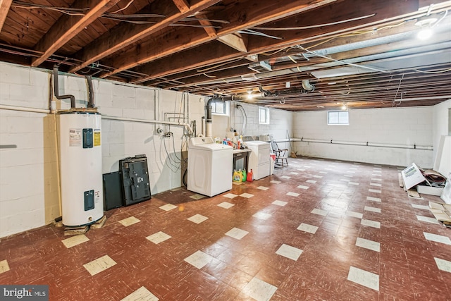 basement featuring washer and clothes dryer and electric water heater