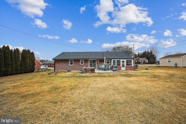 rear view of property with a patio area and a lawn