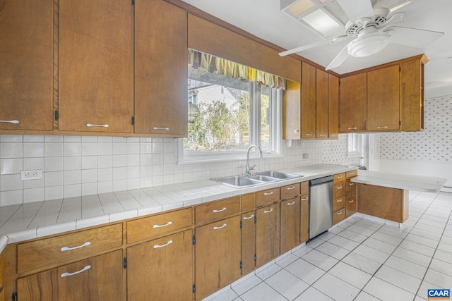 kitchen with sink, tasteful backsplash, light tile patterned floors, dishwasher, and ceiling fan