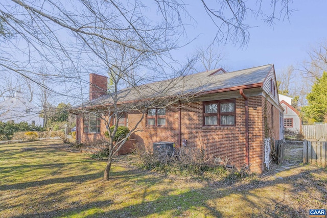 back of house featuring a yard and central air condition unit