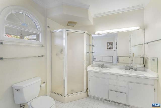 bathroom featuring toilet, ornamental molding, and a shower with shower door