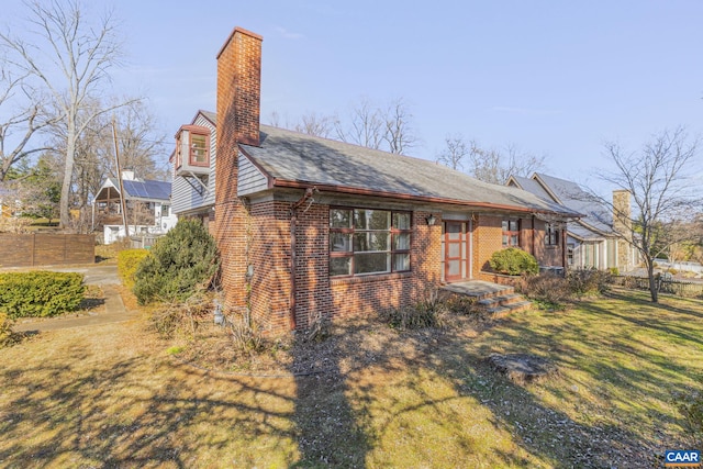 view of side of home featuring a lawn