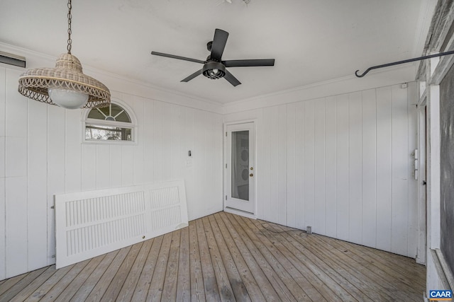 exterior space featuring crown molding, ceiling fan, and light hardwood / wood-style floors