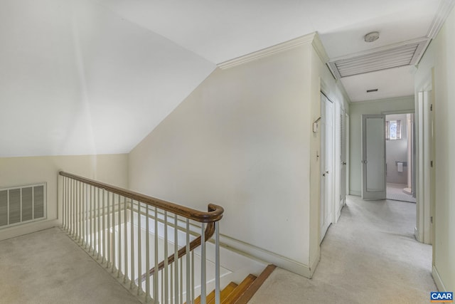 hallway featuring vaulted ceiling and light colored carpet