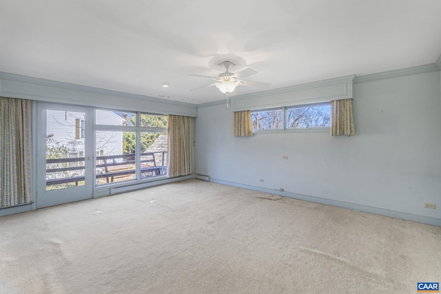 unfurnished room with ornamental molding, ceiling fan, and carpet