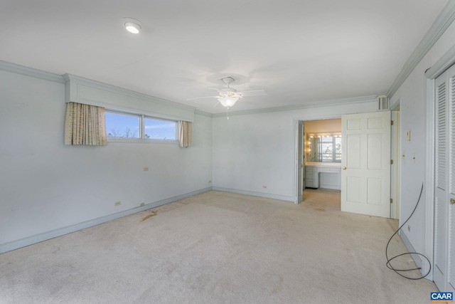 unfurnished bedroom featuring crown molding, ceiling fan, and light carpet