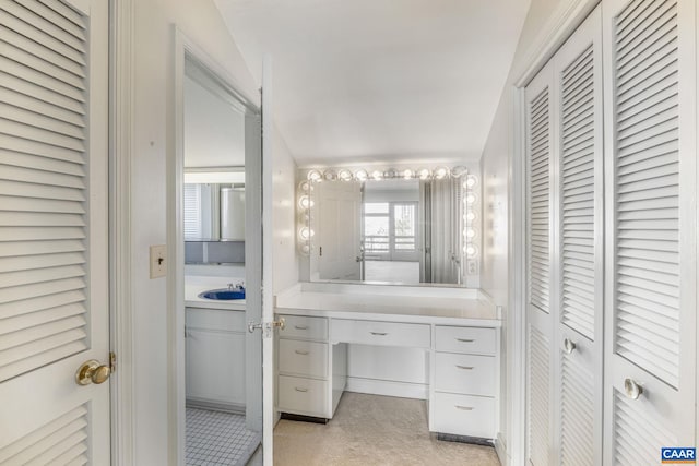 bathroom with vanity and lofted ceiling