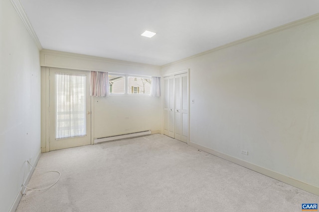 spare room featuring light carpet, ornamental molding, and baseboard heating