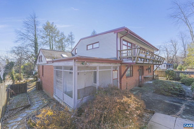 view of side of home with a sunroom