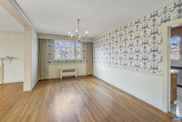 unfurnished dining area with crown molding, radiator heating unit, and plenty of natural light